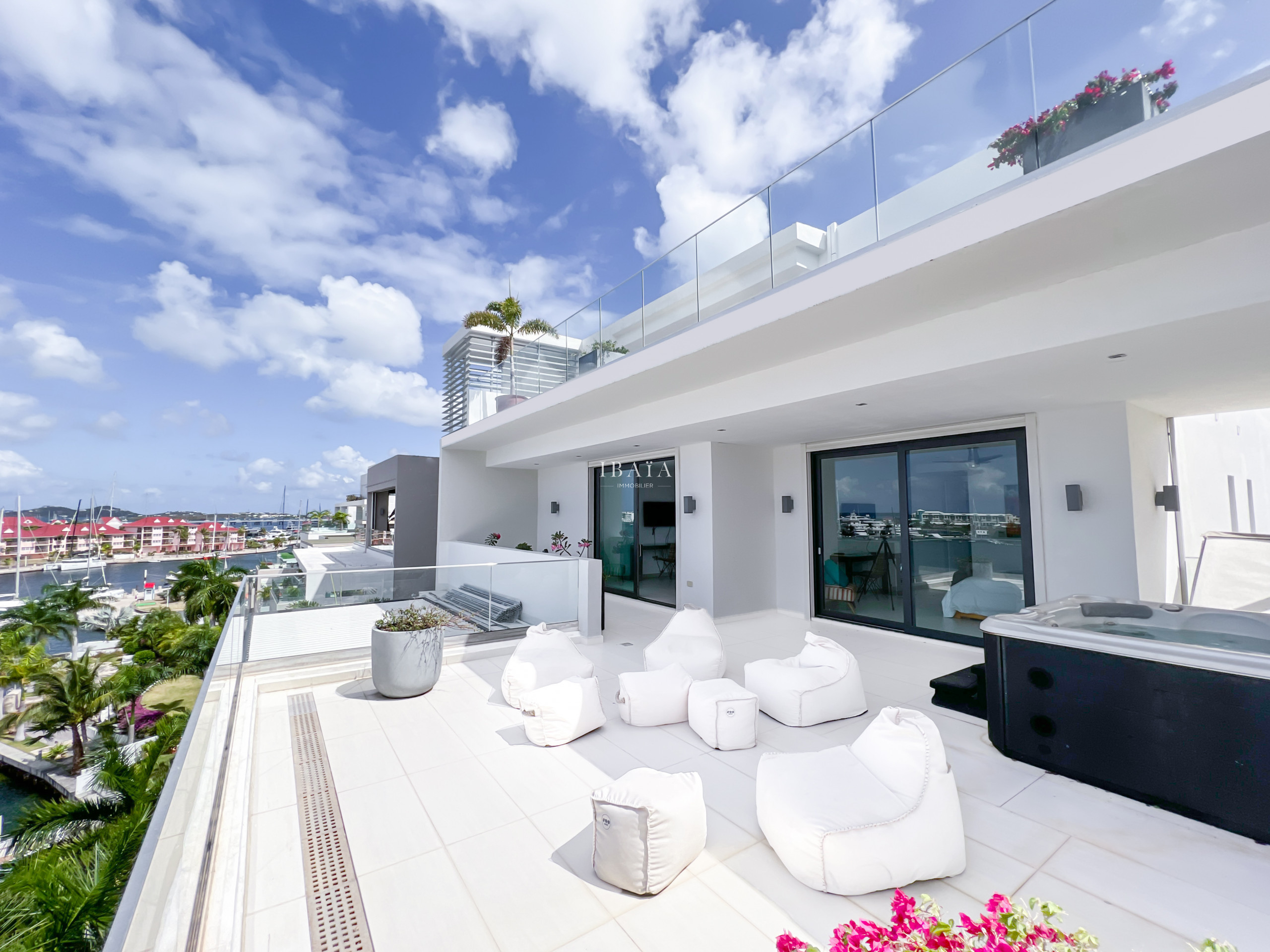 View of the terrace with Jacuzzi and direct access to the bedrooms, small outdoor lounge with panoramic view of the terrace on the upper level of the 