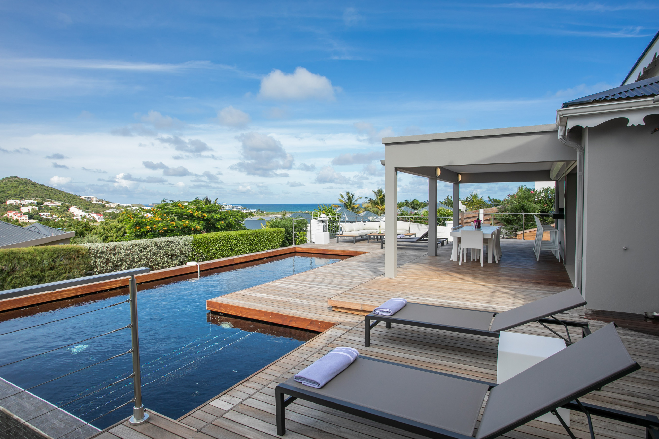 Swimming pool with deckchairs luxury villa West Indies