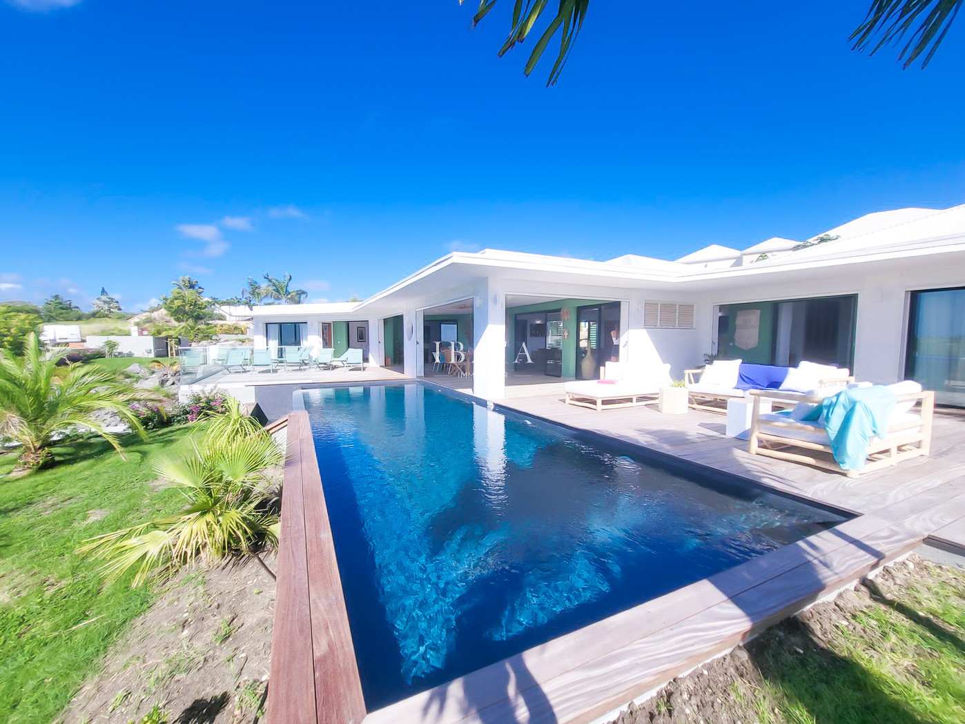 Modern villa with infinity pool and wooden outdoor furniture