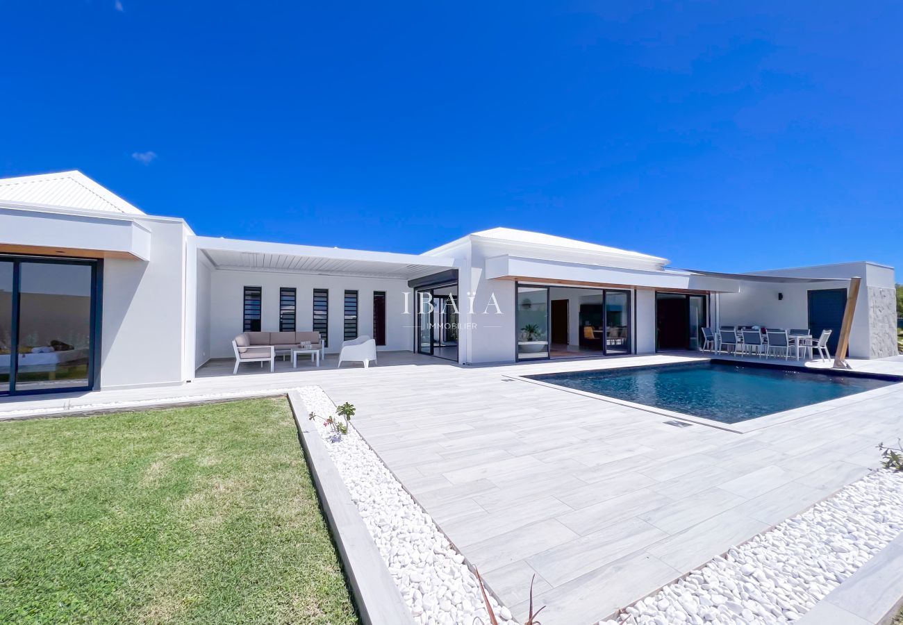 A modern white villa with pool.