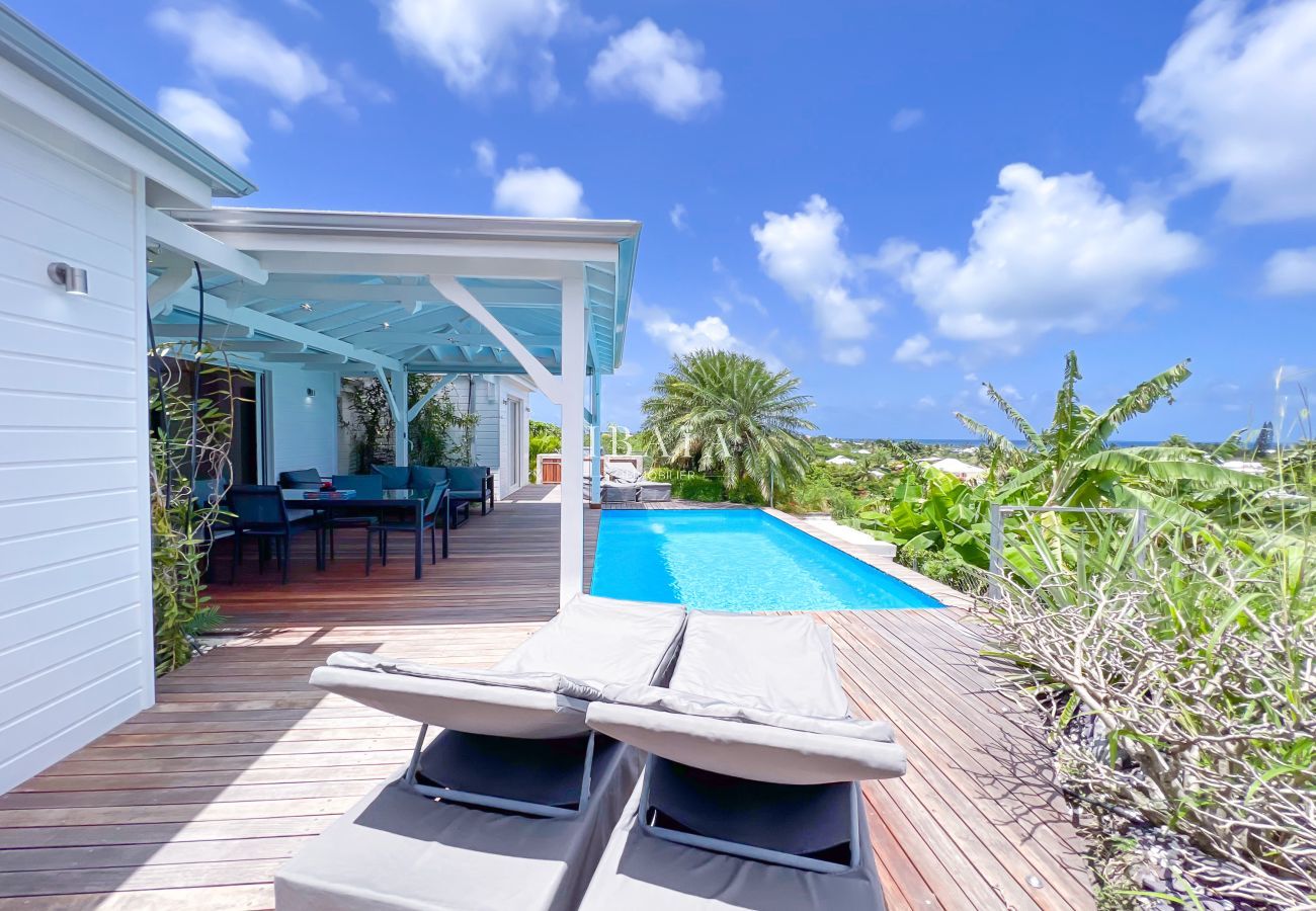 Wooden terrace with pool and garden view