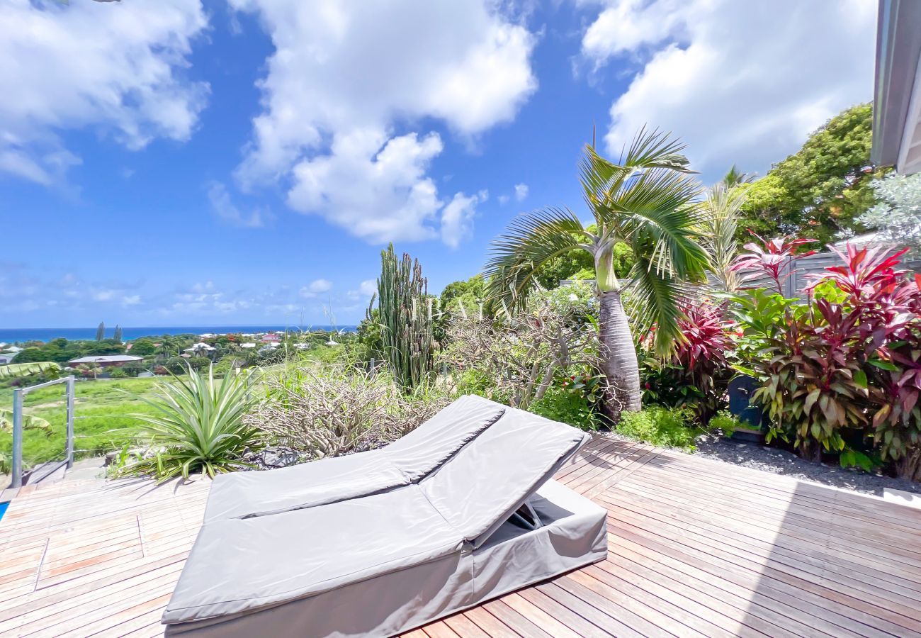 Wooden deck with sun lounger and sea view