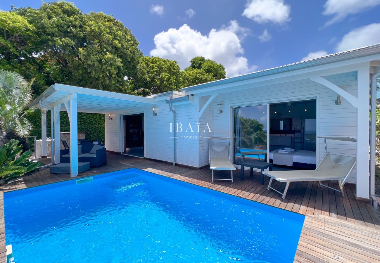 White villa with pool under blue sky