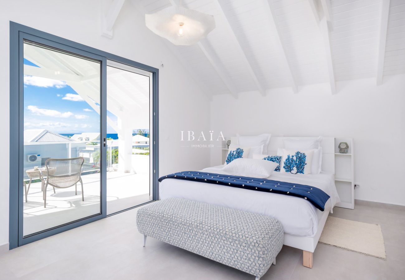 Double bed with balcony view and blue sky