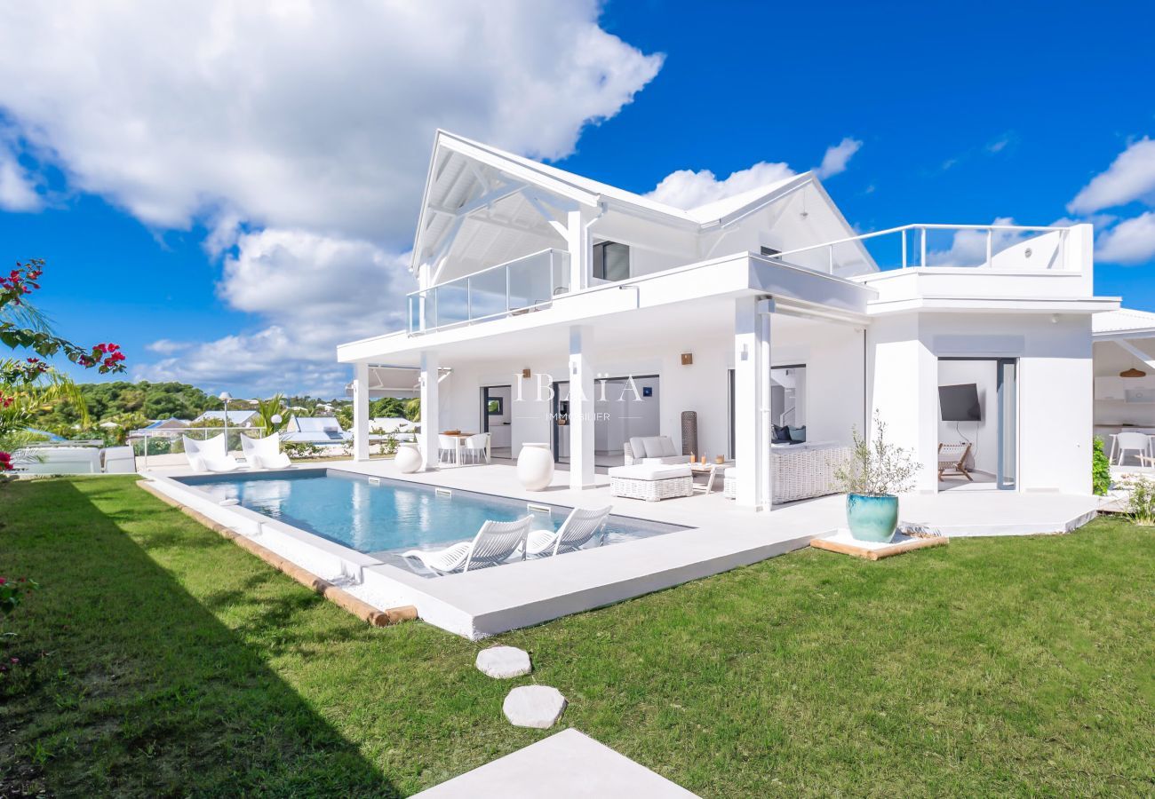 White villa with pool and garden