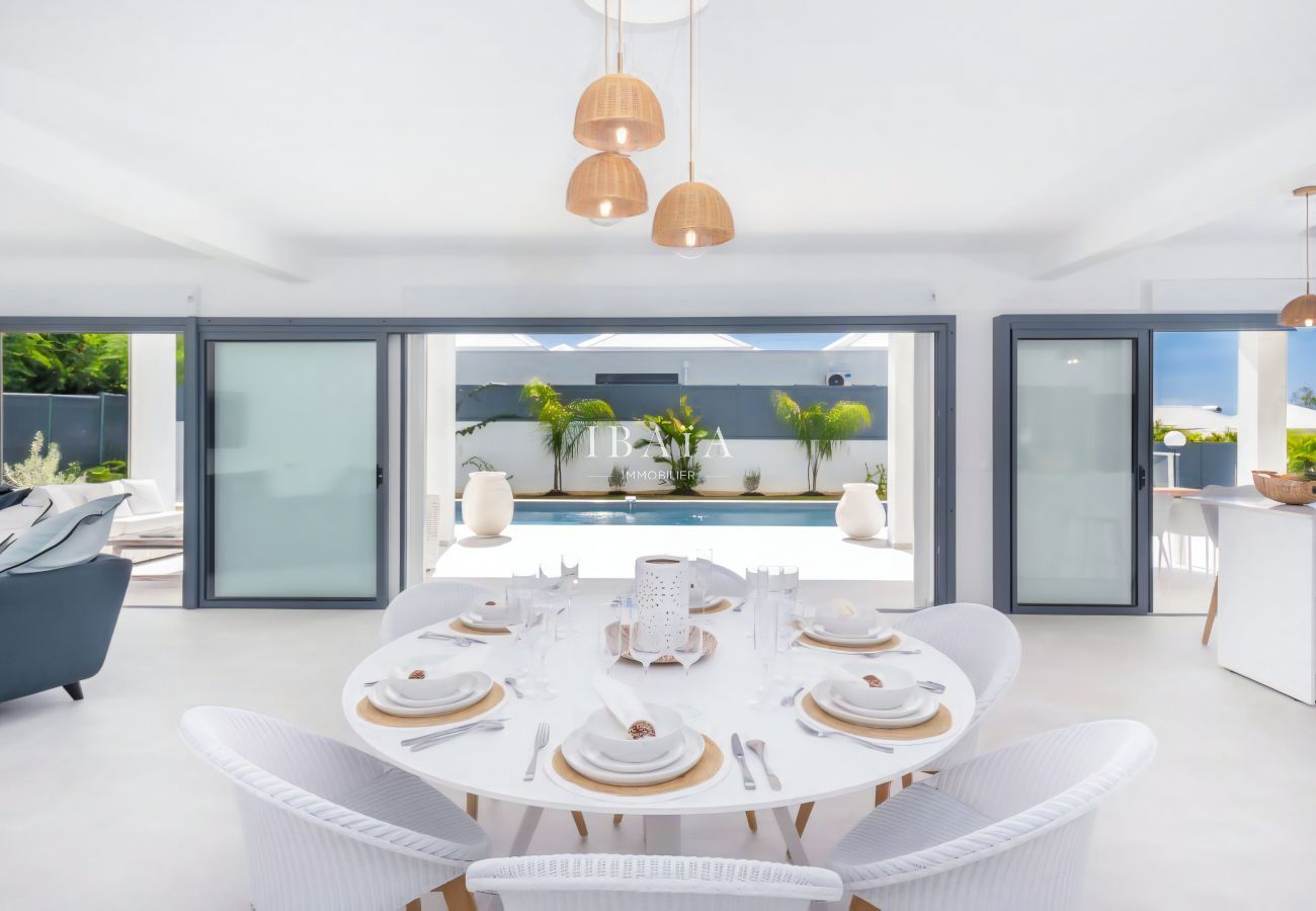 Modern dining room open to the pool area