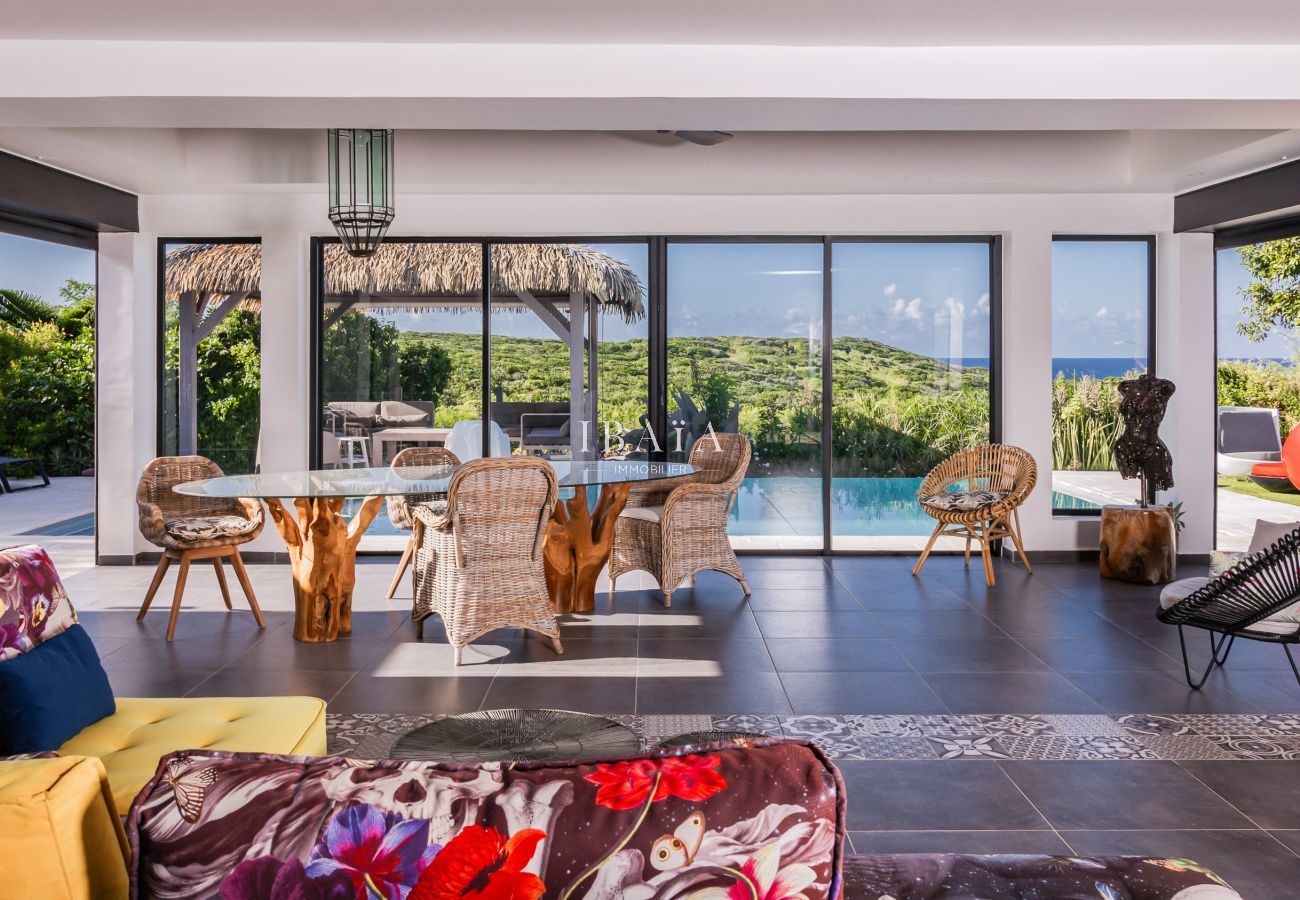 Modern living room with pool and nature view