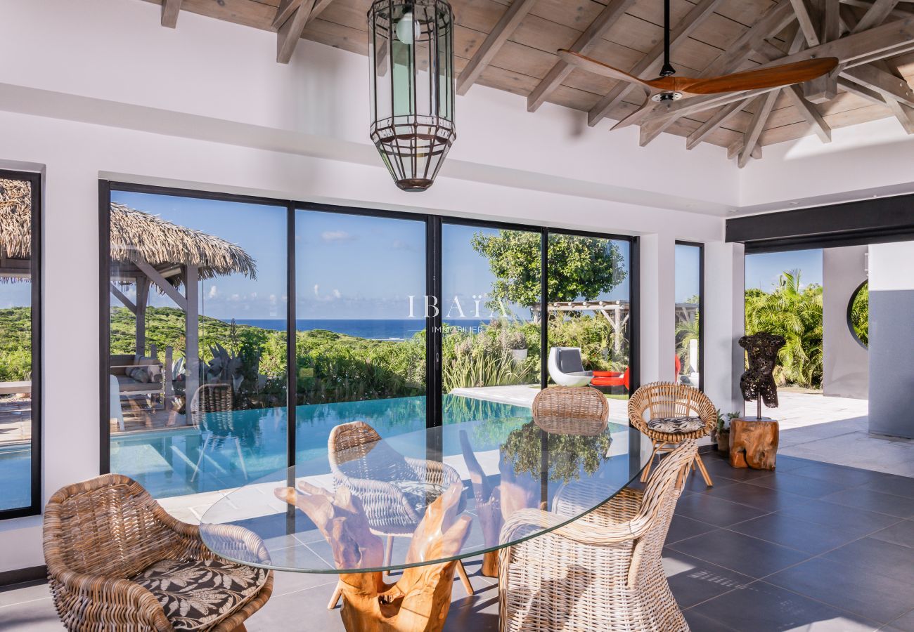 Glass table, chairs, and pool view