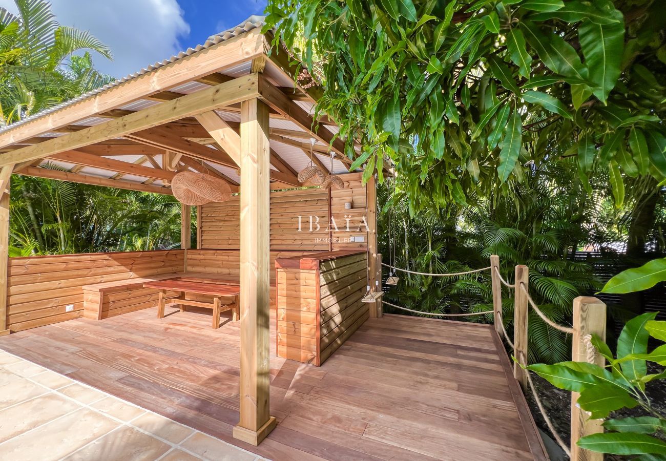 Teak wood gazebo offering a view of the pool