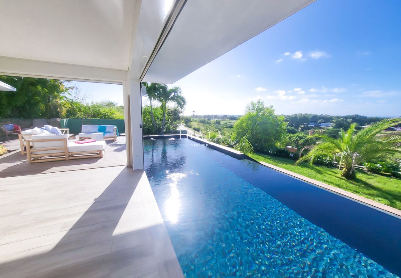 Infinity pool overlooking a lush tropical landscape