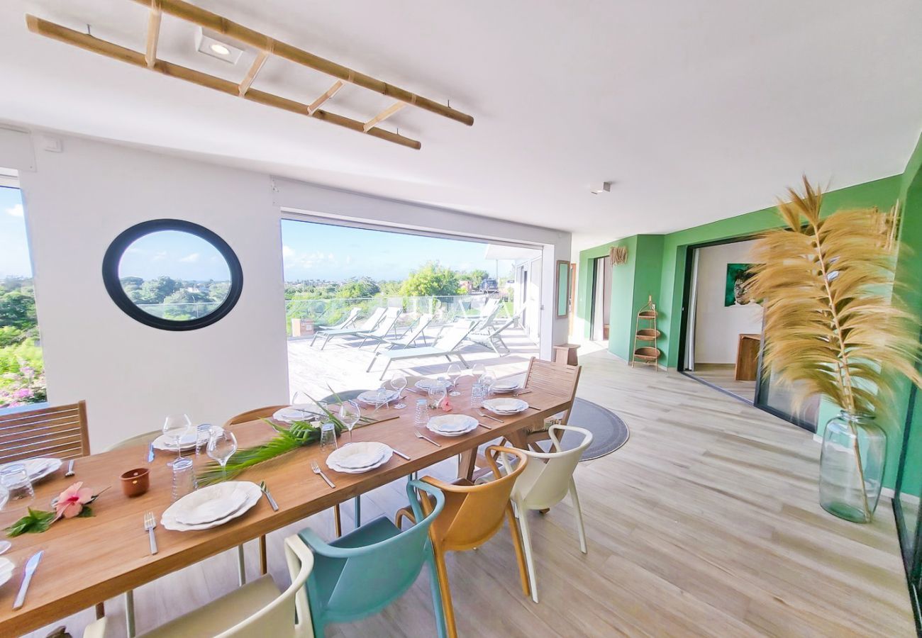 Bright dining room overlooking terrace and pool