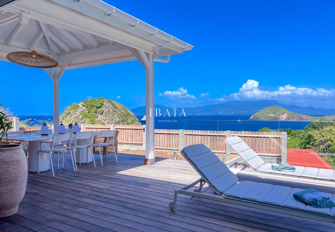 Transats et table à manger avec vue sur la mer